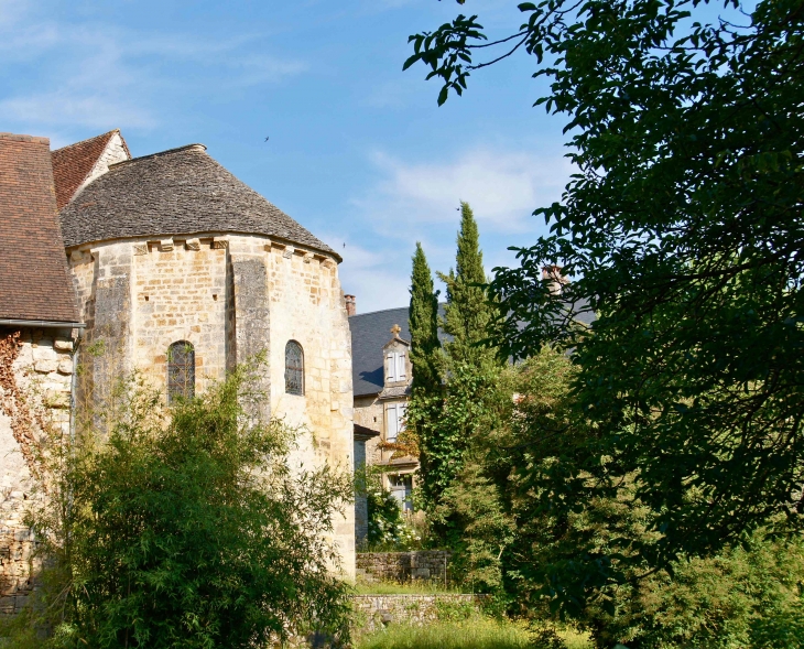 Le chevet recouvert de lauze de l'église Saint ours. Au fond le presbytère. - Sainte-Orse