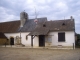 L'église 14ème et son clocher mur et la mairie attenante.