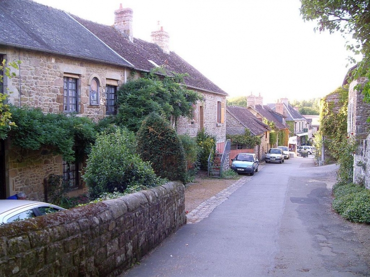 La rue de l' église à Saint Céneri. - Saint-Céneri-le-Gérei