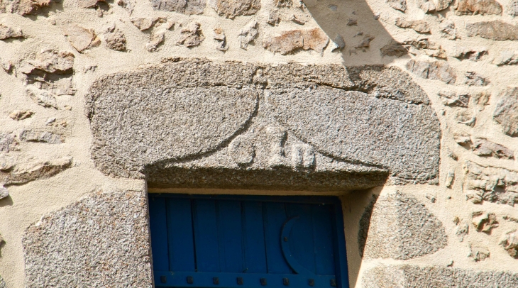 Linteau de granit sculpté. - Saint-Baudelle