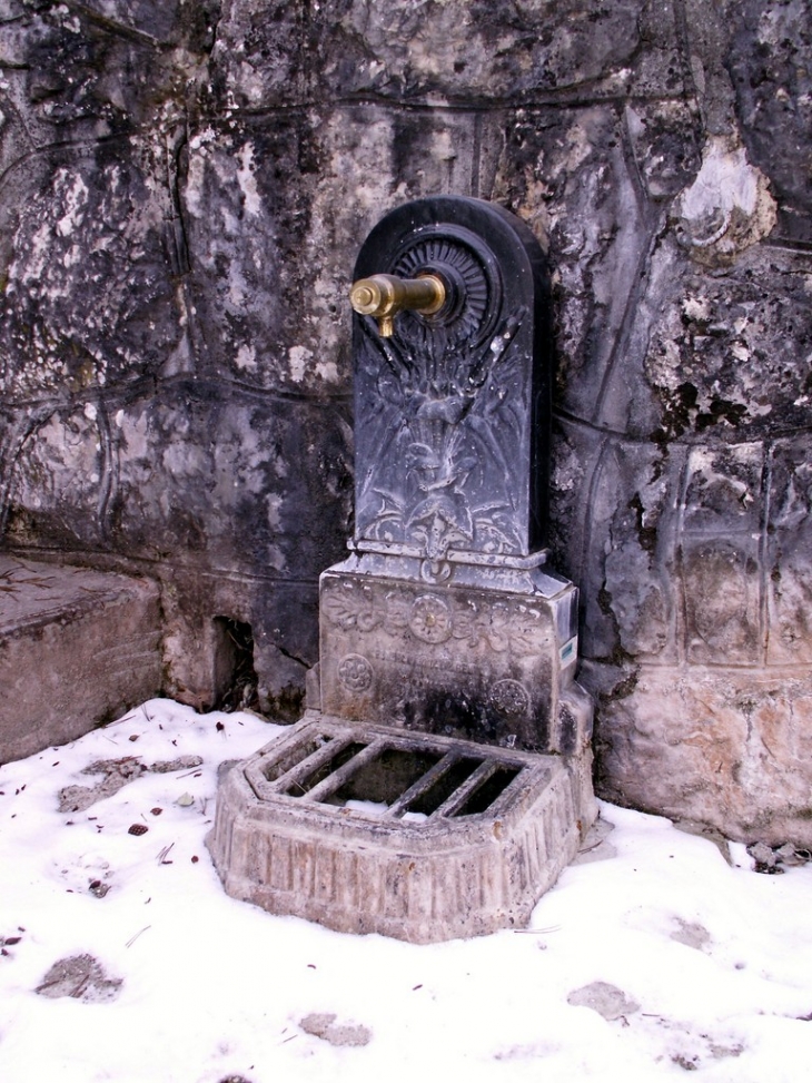 Fontaine à proximité de l'église sur la place du village - Mûres